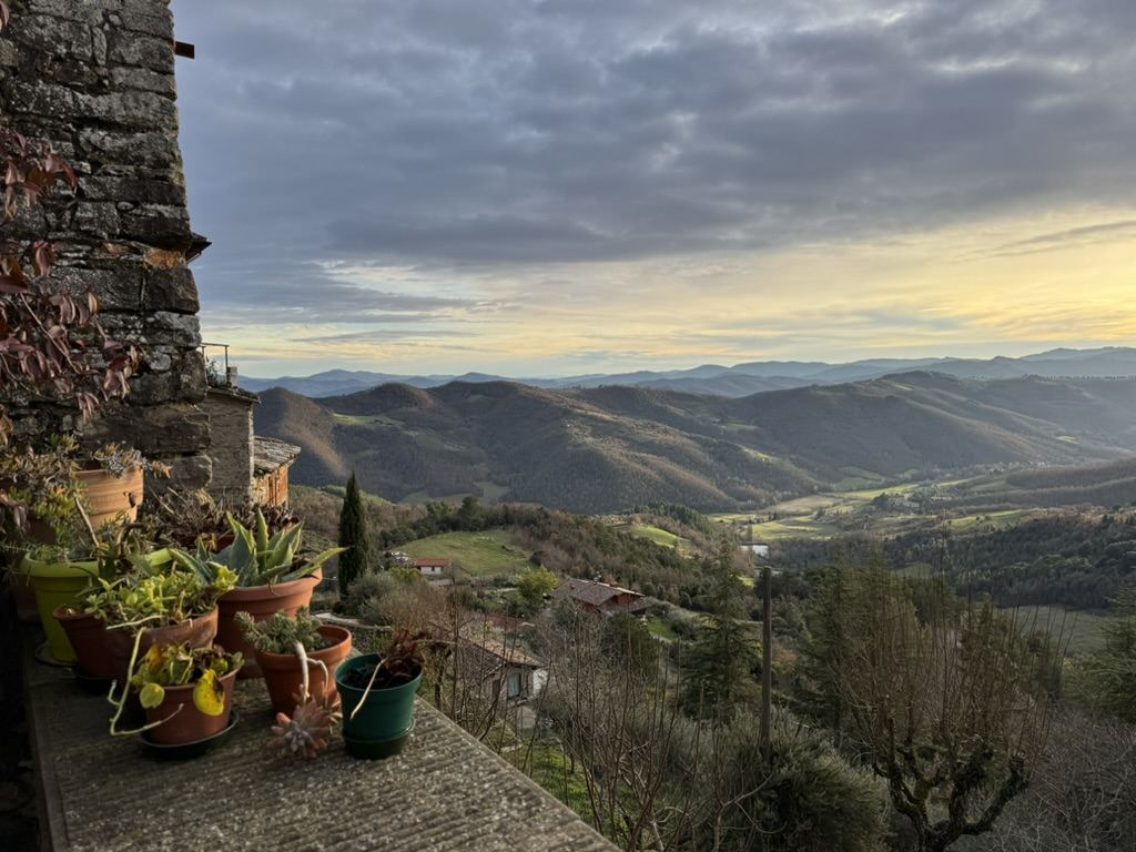 The hilltop village with snow-capped mountains behind